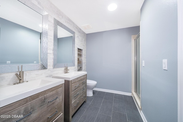 bathroom featuring toilet, an enclosed shower, and vanity