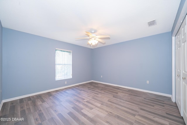 unfurnished bedroom featuring wood-type flooring, ceiling fan, and a closet