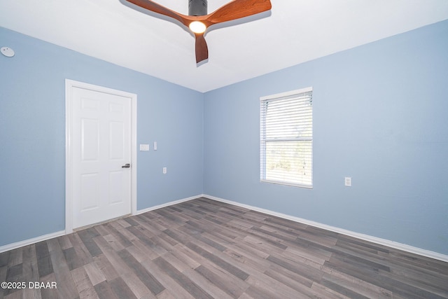 spare room featuring ceiling fan and dark wood-type flooring