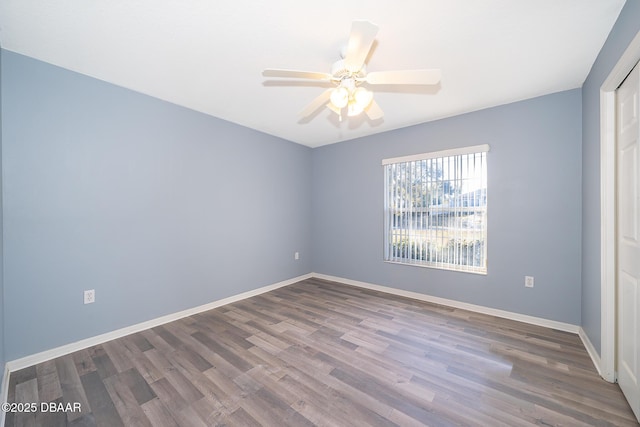 spare room with hardwood / wood-style flooring and ceiling fan