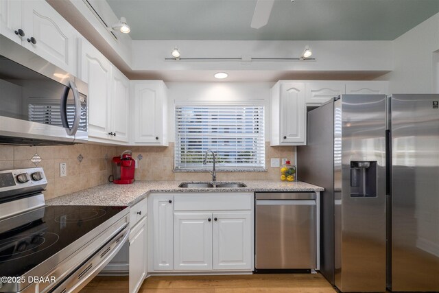 kitchen with a breakfast bar, light stone countertops, white cabinetry, and an inviting chandelier