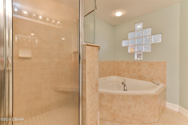 bathroom with plus walk in shower, a textured ceiling, and tile patterned floors