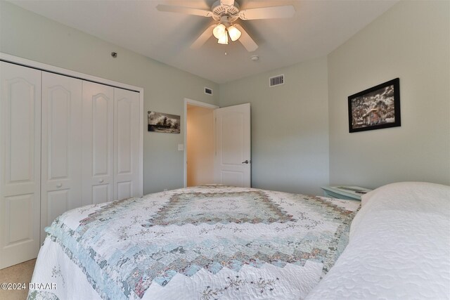 bedroom with carpet, ceiling fan, and a closet