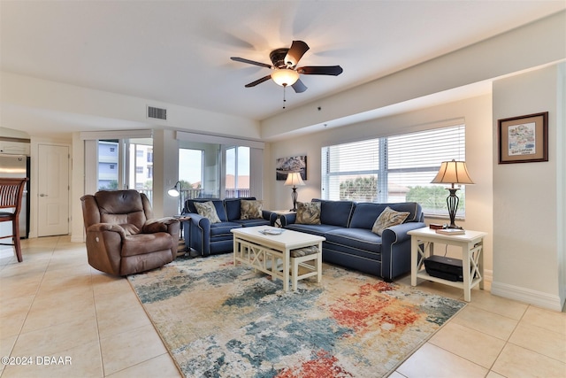 living room with ceiling fan and light tile patterned flooring