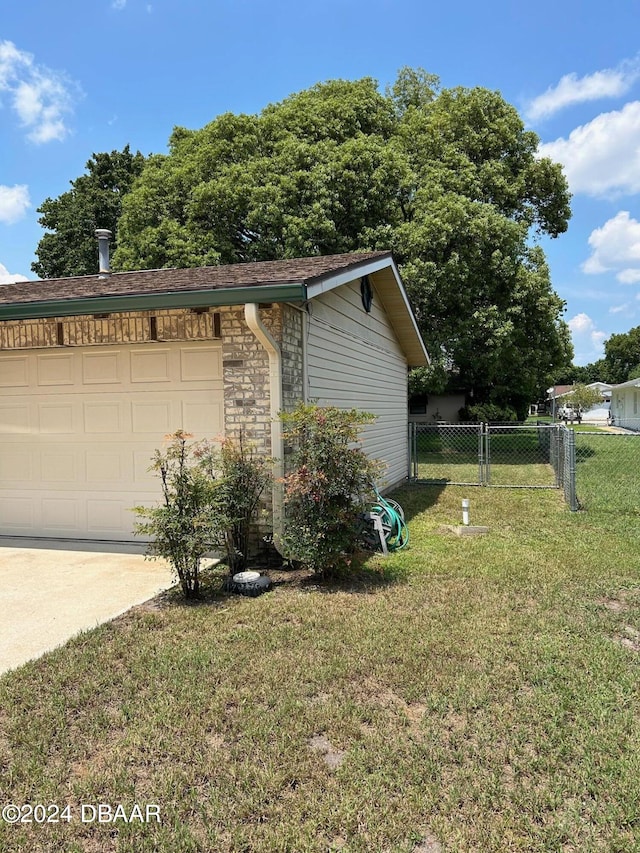 view of home's exterior featuring a yard and a garage