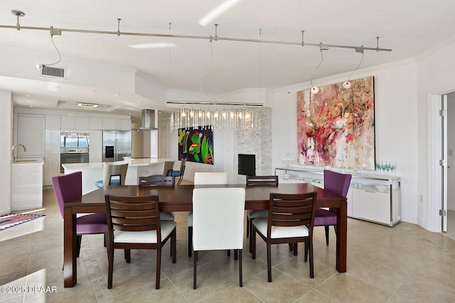 dining room with visible vents, ornamental molding, and light tile patterned flooring