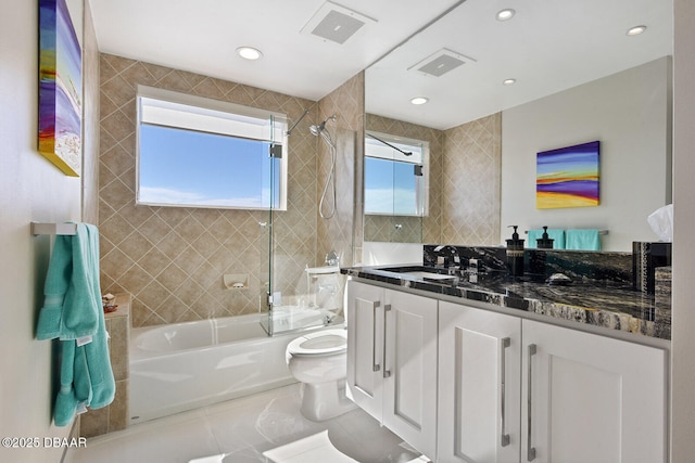 full bathroom with tile patterned floors, visible vents, toilet, shower / bathing tub combination, and vanity