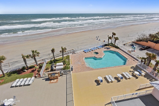 drone / aerial view with a water view and a view of the beach