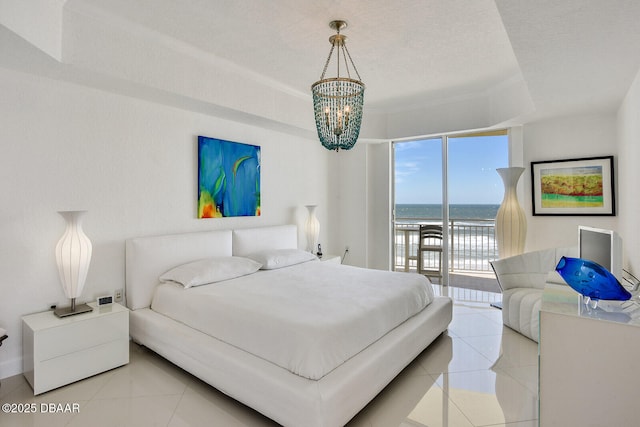 tiled bedroom with access to exterior, a notable chandelier, a raised ceiling, and a textured ceiling