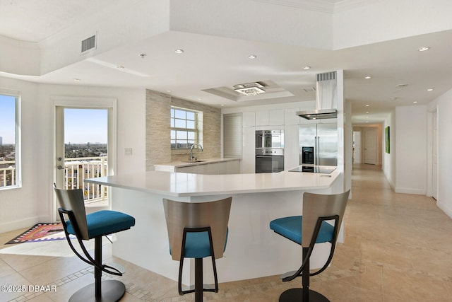 kitchen featuring visible vents, a sink, light countertops, appliances with stainless steel finishes, and modern cabinets