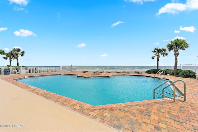 community pool featuring a patio area and fence