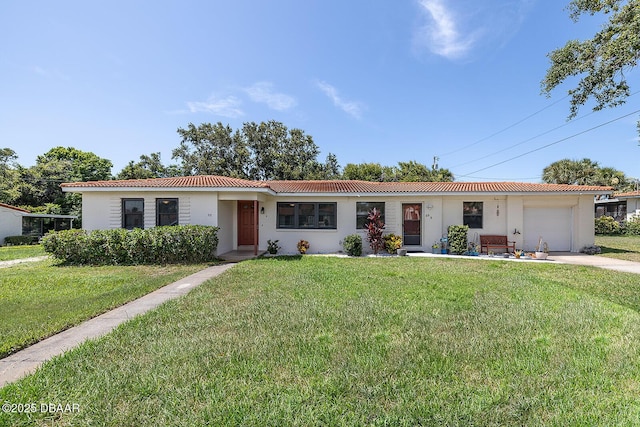 59 Cardinal Dr Unit A, Ormond Beach, FL 32176 - ranch-style house featuring a tiled roof, a garage, a front yard, and stucco siding