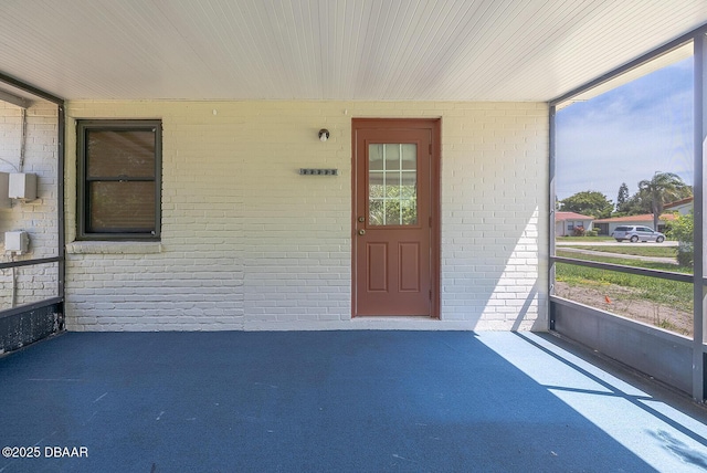 59 Cardinal Dr Unit A, Ormond Beach, FL 32176 - view of exterior entry featuring brick siding