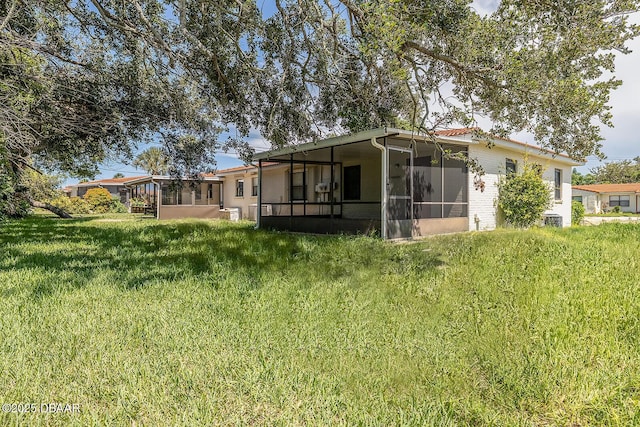 59 Cardinal Dr Unit A, Ormond Beach, FL 32176 - rear view of property featuring a sunroom and a yard