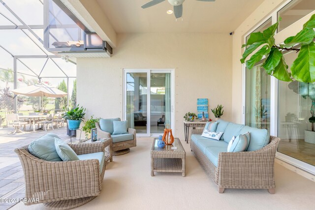 view of patio featuring an outdoor living space, outdoor dining space, a ceiling fan, and a lanai