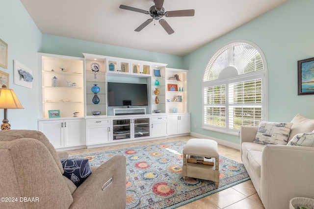 living room featuring light tile patterned flooring, baseboards, and ceiling fan