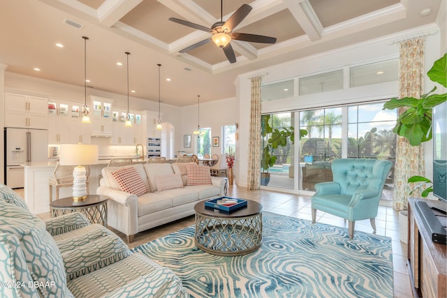 living room with light tile patterned flooring, beamed ceiling, a ceiling fan, a high ceiling, and coffered ceiling