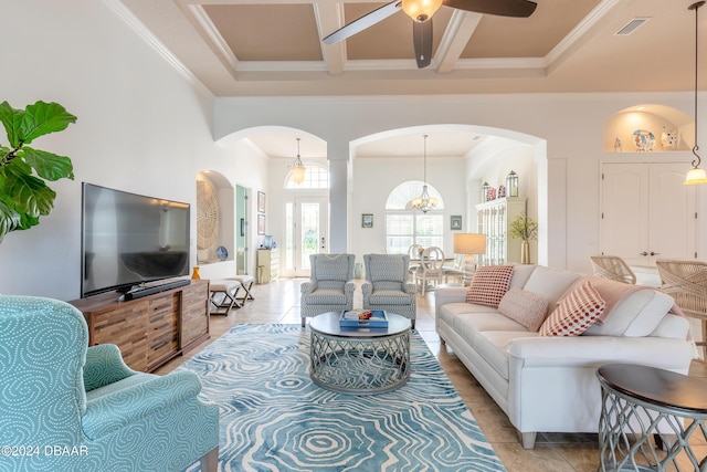living room with ceiling fan, a towering ceiling, arched walkways, coffered ceiling, and light tile patterned floors