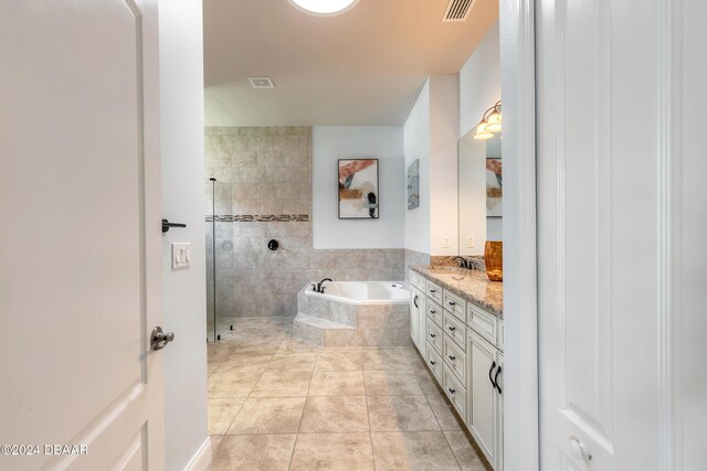 full bathroom featuring a bath, visible vents, a tile shower, tile patterned floors, and vanity