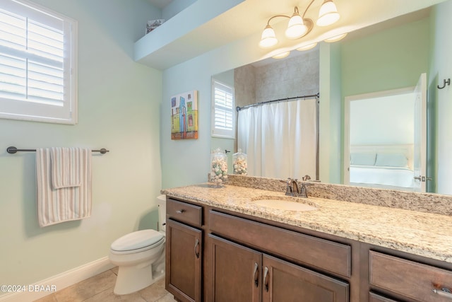 bathroom featuring a shower with shower curtain, baseboards, toilet, vanity, and tile patterned flooring