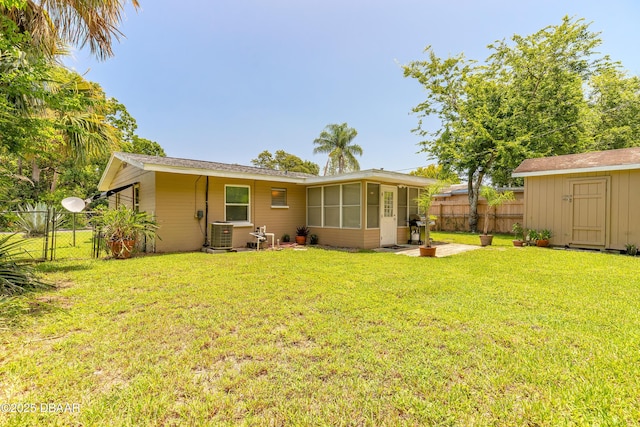 125 Azalea Dr, Daytona Beach, FL 32117 - rear view of house with a sunroom, a storage shed, and a gate