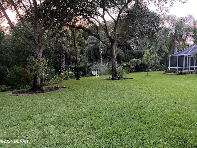 view of yard featuring glass enclosure