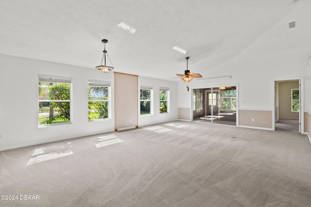 unfurnished living room with ceiling fan, light colored carpet, and a healthy amount of sunlight