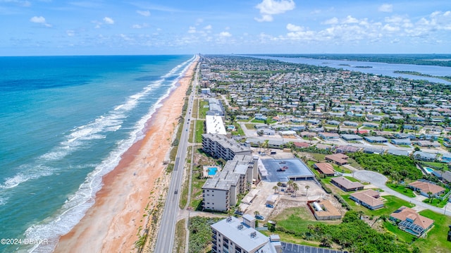 drone / aerial view featuring a view of the beach and a water view