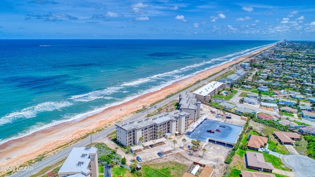 bird's eye view featuring a view of the beach and a water view