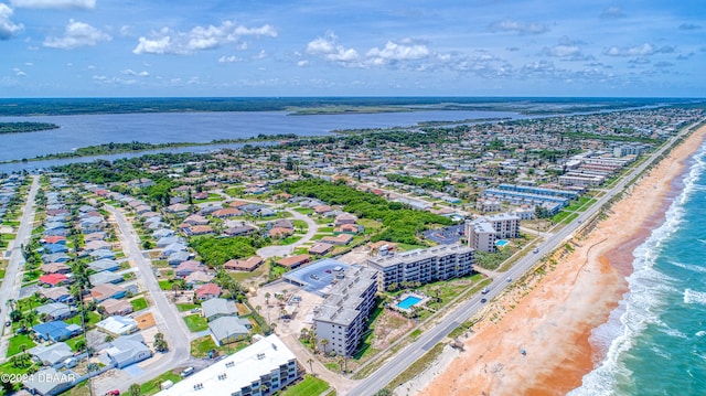 birds eye view of property featuring a beach view and a water view