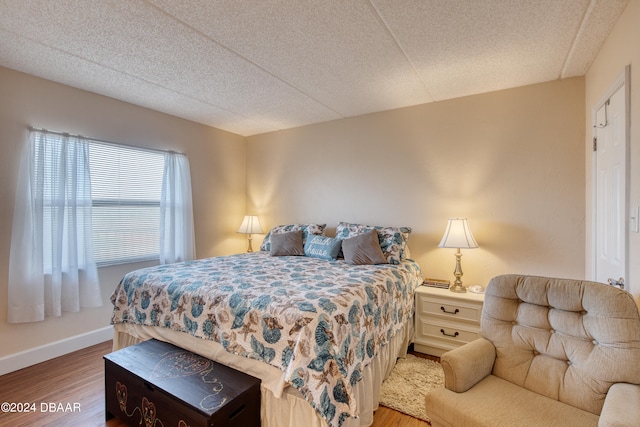 bedroom with wood-type flooring and a textured ceiling