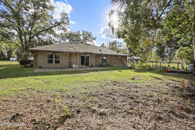 back of property featuring a lawn