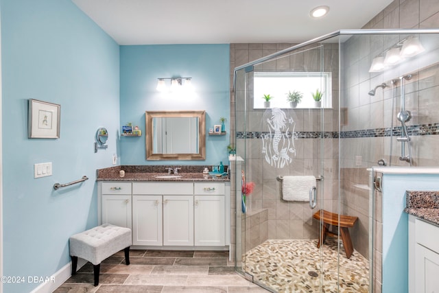 bathroom featuring an enclosed shower and vanity