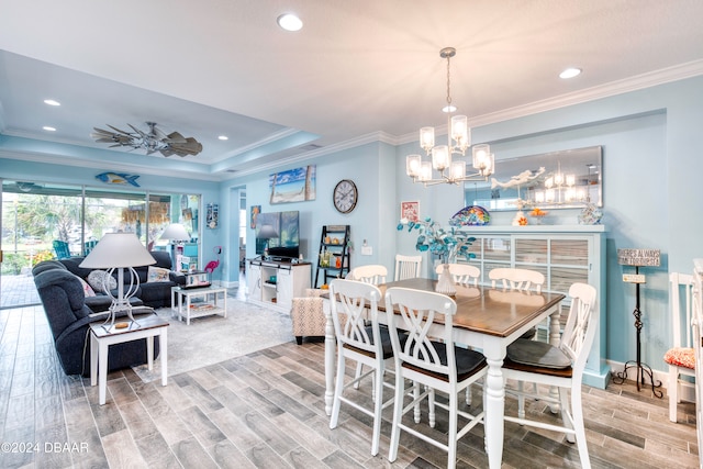 dining area featuring hardwood / wood-style flooring, a chandelier, and crown molding