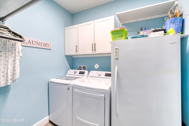 laundry room featuring washing machine and dryer and cabinets