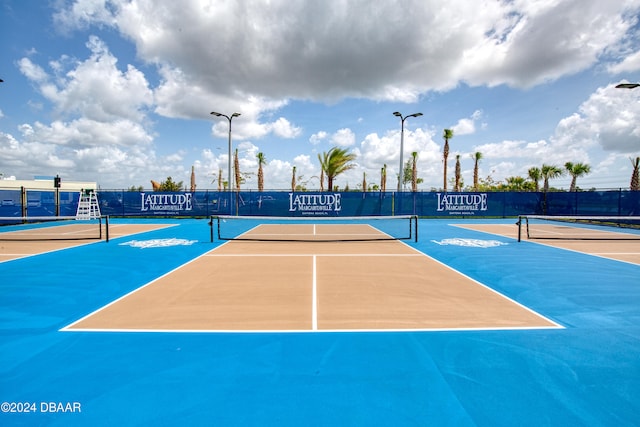 view of sport court with basketball hoop