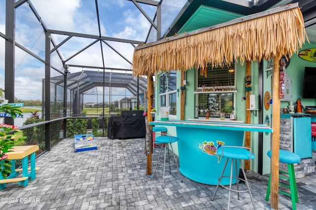 view of patio / terrace with glass enclosure and exterior bar