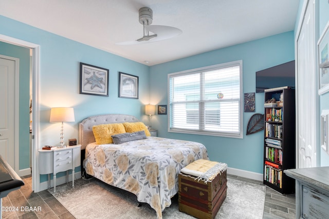 bedroom with hardwood / wood-style floors and ceiling fan