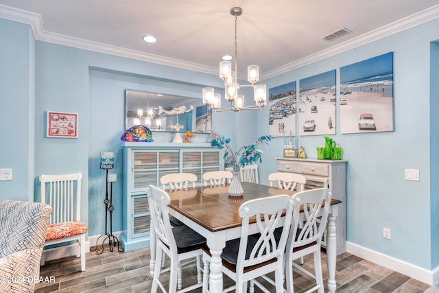 dining area featuring an inviting chandelier, hardwood / wood-style flooring, and ornamental molding