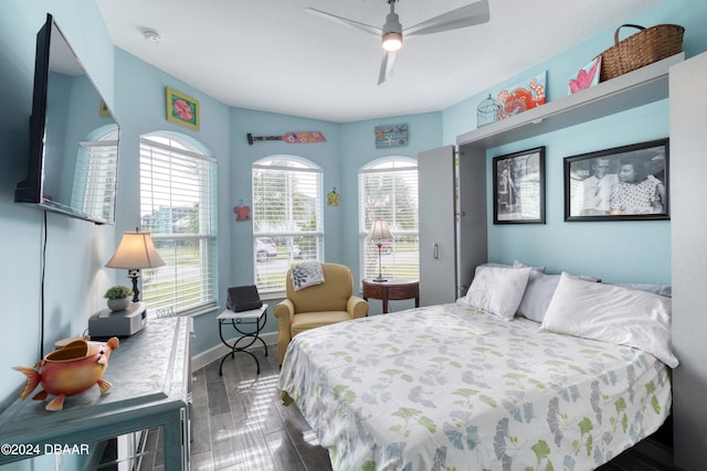 bedroom featuring ceiling fan and dark hardwood / wood-style floors