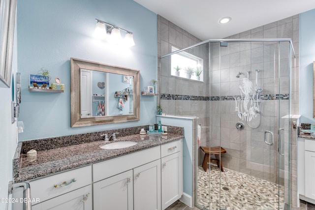 bathroom featuring vanity and a shower with shower door