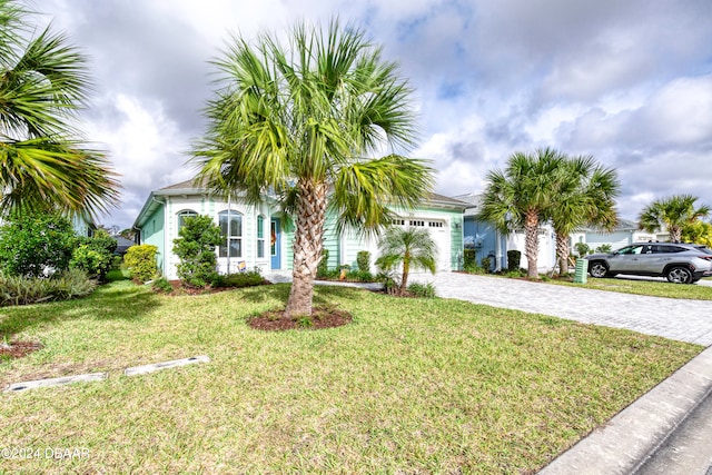 view of front of property with a garage and a front lawn