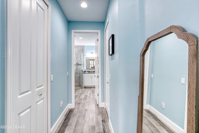 corridor with wood-type flooring