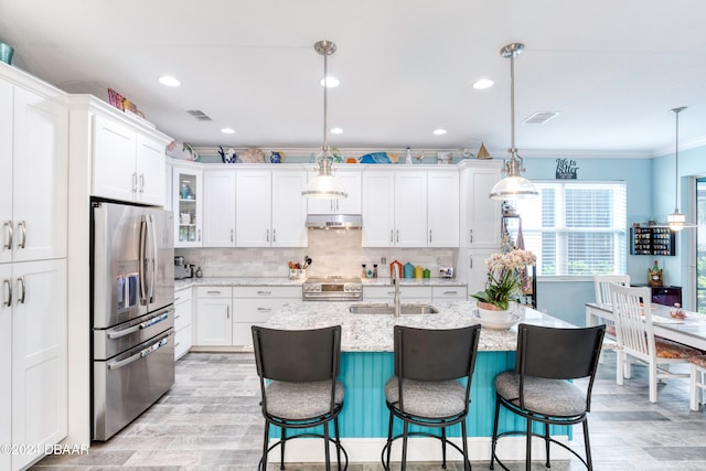 kitchen with sink, appliances with stainless steel finishes, decorative light fixtures, and crown molding