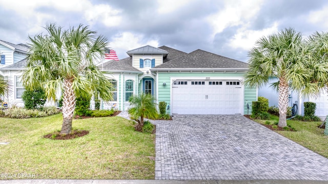 view of front of property with a garage and a front yard