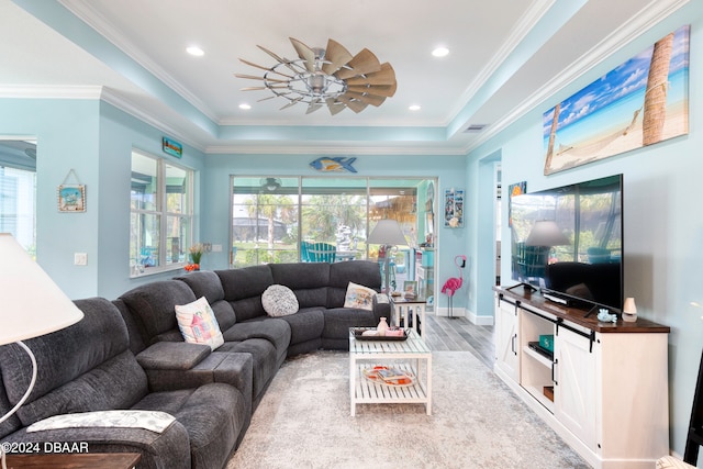 living room featuring light hardwood / wood-style flooring, ceiling fan, and crown molding