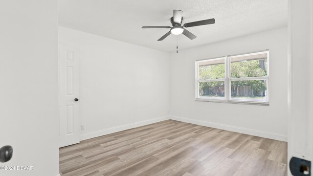 1801 James St, South Daytona, FL 32119 - unfurnished room with light wood-style flooring, baseboards, ceiling fan, and a textured ceiling
