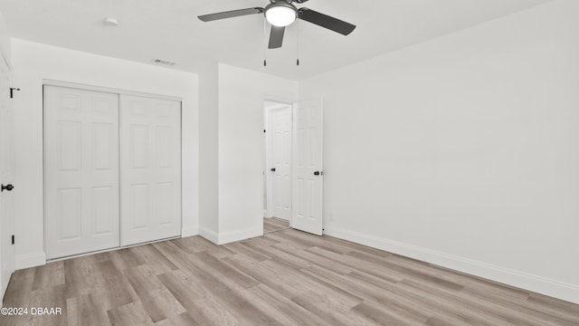 1801 James St, South Daytona, FL 32119 - unfurnished bedroom with wood finished floors, baseboards, a closet, and a ceiling fan