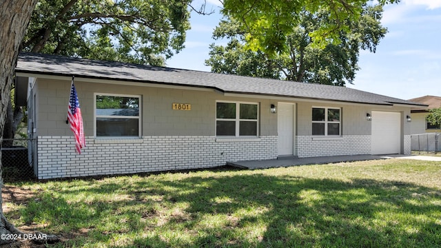 single story home featuring a garage and a front yard