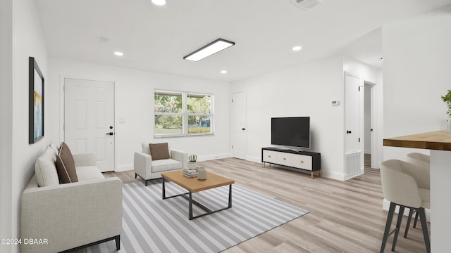 1801 James St, South Daytona, FL 32119 - living area featuring light wood finished floors, recessed lighting, and baseboards
